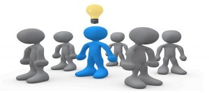 One Blue Person In A Group Of Gray People, Thinking Up A Creative Idea, With A Lightbulb Over His Head Clipart Illustration Graphic